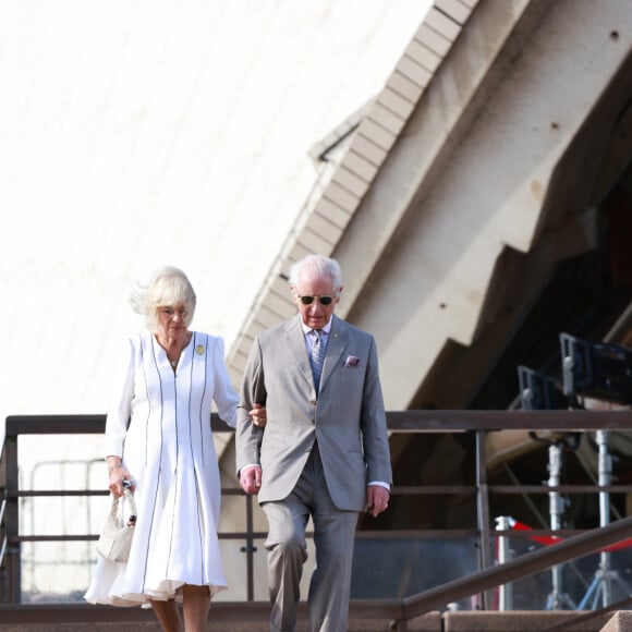 Le roi Charles III d'Angleterre et Camilla Parker Bowles, reine consort d'Angleterre, descendent l'escalier de l'opéra de Sydney lors de leur visite officielle en Australie, le 22 octobre 2024. 