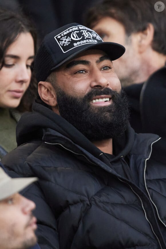 Le rappeur La Fouine en tribunes du match de Ligue 1 McDonald's opposant le Paris Saint-Germain (PSG) au Racing Club de Lens (RCL) (1-0) au Parc des Princes à Paris, France, le 2 novembre 2024. © Cyril Moreau/Bestimage