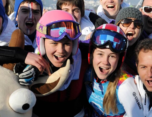 Clara Direz (à d.) et Estelle Alphand (à g., casque rose) posent avec la délégation française après leur doublé or-argent dans le slalom géant aux Jeux Olympiques d'Hiver de la Jeunesse d'Innsbruck, le 18 janvier 2012.