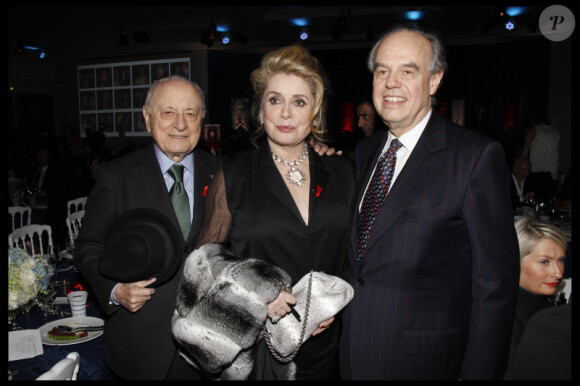 Pierre Bergé, Catherine Deneuve et Frédéric Mitterrand au Dîner de la mode pour le Sida au Pavillon d'Armenonville à Paris, le 26 janvier 2012.