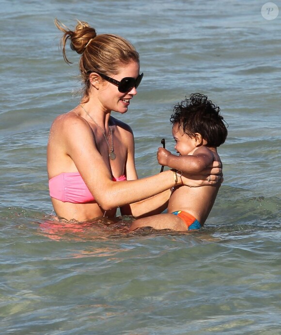 Doutzen Kroes batifole avec son fils Phyllon sur une plage à Miami. Le 24 mars 2012.
