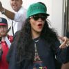 Rihanna, habillée d'un minishort et de bottines Chloë Sevigny pour Opening Ceremony et d'un pull Kenzo, une casquette de la même marque sur la tête, sort de son hôtel londonien. Le 28 août 2012.