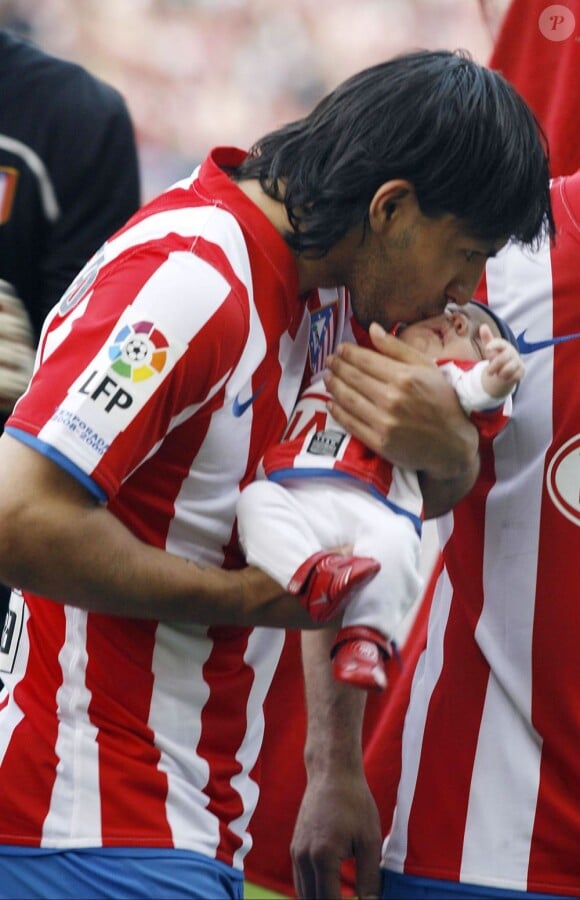 Sergio Agüero présente son fils Benjamin aux supporters de l'Atletico Madrid le 15 mars 2009.