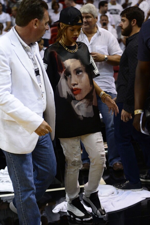 Rihanna assiste au match de NBA entre les Miami Heat et les Milwaukee Bucks à Miami, habillée d'une casquette +Fresh.i.Am+, d'un t-shirt Givenchy personnalisé et de baskets Nike Air Jordan 13. Le 21 Avril 2013.