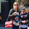 Nicky Hilton dans les rues de New York, porte un sac matelassé rouge Chanel et des baskets Isabel Marant. Le 25 avril 2013.