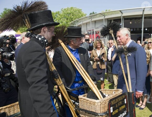 Le prince Charles et Camilla Parker Bowles le 11 juillet 2013 au premier jour du Coronation Festival organisé à Buckingham Palace, à l'occasion des 60 ans du couronnement d'Elizabeth II, par la Royal Warrants Holders Association.