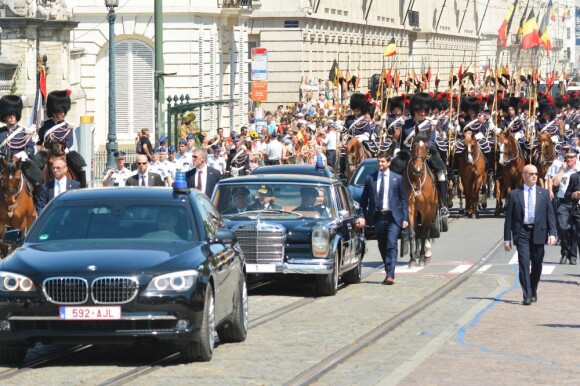 Le roi Philippe et la reine Mathilde de Belgique à bord d'une Mercedes 600 décapotable munie de la plaque d'immatriculation "1", réservée au souverain belge, à Bruxelles, le 21 juillet 2013.