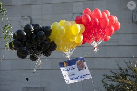 Des ballons aux couleurs du drapeau belge s'envole avec la photo du nouveau roi Philippe à Bruxelles, le 21 juillet 2013.