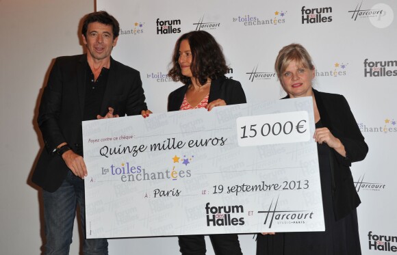 Gisèle Tsobanian, directrice de l'association Les Toiles Enchantées, entourée de Patrick Bruel et Isabella Nanty, lors de l'inauguration de l'expo photo Stars parmi les stars organisée par le Studio Harcourt et le Forum des Halles au profit de l'association Les Toiles Enchantées, le 19 septembre 2013 à Paris.