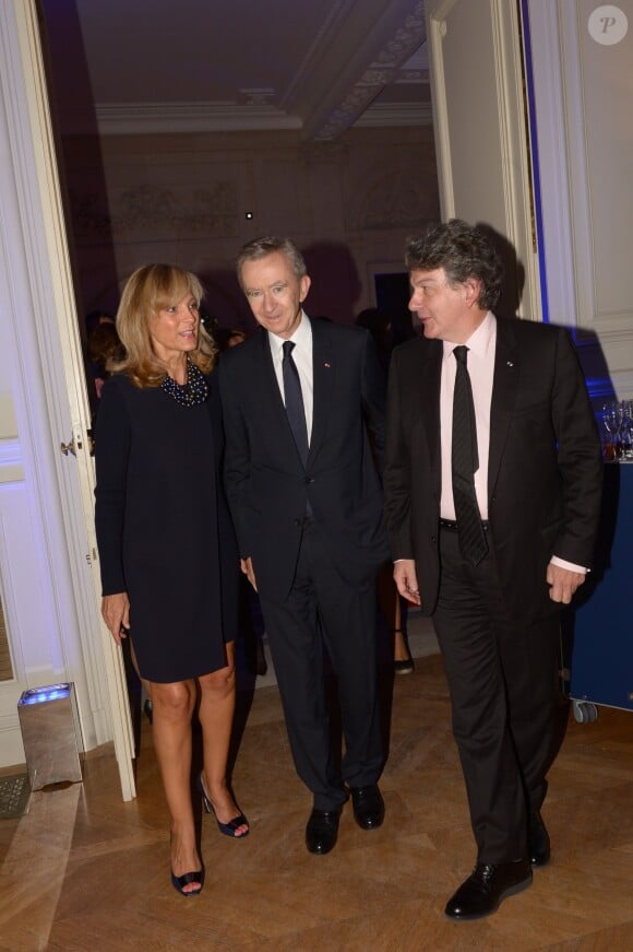 Bernard Arnault et son épouse avec Thierry Breton à la soirée des 80 ans d'Air France, à Paris, le 7 octobre 2013.