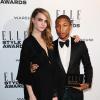 Cara Delevingne et Pharrell Williams, nommé artiste international de l'année lors des ELLE Style Awards au One Embankment. Londres, le 18 février 2014.