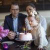 La princesse Estelle de Suède soufflant les bougies pour son 2e anniversaire, le 23 février 2014, sous le regard de ses parents la princesse Victoria et le prince Daniel.