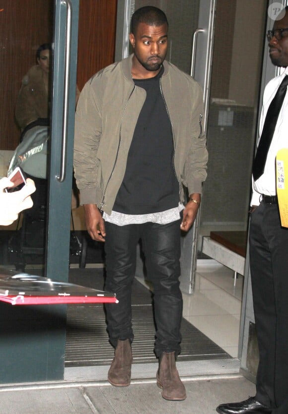 Kanye West quitte son appartement, suivi par Kim Kardashian et leur fille North. New York, le 25 février 2014.