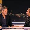 George Clooney hilare devant Jean Dujardin avant de tourner une interview pour le journal télévisé de TF1.