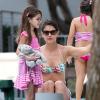 Katie Holmes se relaxe au bord d'une piscine avec sa fille Suri à Miami, le 1er janvier 2014.