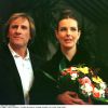 15e Midem à Cannes avec Gérard Depardieu15EME MIDEM 1997 CANNES "CAROLE BOUQUET" "GERARD DEPARDIEU" SOURIANT BOUQUET DE FLEURS "PLAN SERRE"20/01/1997 -