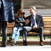 Nicolas Sarkozy et sa femme Carla Bruni se prélassent sur un banc du lycée de leur bureau de vote dans le 16e arrondissement à Paris, le 23 mars 2014.