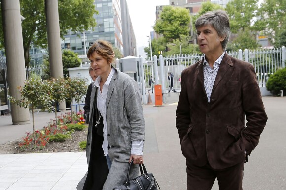 Sylvie Uderzo et son mari Bernard de Choisy arrivent au tribunal correctionnel de Nanterre pour le procès qui les oppose à son père Albert Uderzo, le 3 juin 2014.