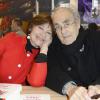 Macha Méril et son fiancé Michel Legrand lors du 34e Salon du livre de Paris, Porte de Versailles, le 23 mars 2014.