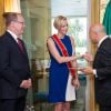 La princesse Charlene de Monaco, enceinte de 5 mois, recevait le 28 juillet 2014 à l'ambassade d'Italie en principauté les insignes de Cavaliere di Gran Croce dell'Ordine della Stella d'Italia (chevalier grand-croix - le plus haut grade - de l'ordre de l'Etoile d'Italie), des mains de l'ambassadeur Antonio Morabito et en reconnaissance de ses actions philanthropiques. Photo : Palais princier de Monaco.