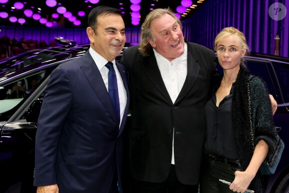 Carlos Ghosn, Gérard Depardieu et Emmanuelle Béart lors de la soirée d'inauguration des nouvelles Renault Espace et Clio lors du salon de l'automobile au Parc des Expositions de la porte de Versailles à Paris, le 2 octobre 2014.