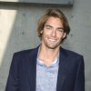 Camille Lacourt au défilé de mode Giorgio Armani, collection printemps-été 2014, lors de la fashion week de Milan, le 23 septembre 2013