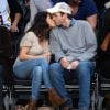 Mila Kunis et son fiancé Ashton Kutcher s'embrassent au match de basket des Lakers face au Thunder d'Oklahoma City, à Los Angeles, le 19 décembre 2014.