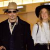 Johnny Depp et sa fiancée Amber Heard arrivent à l'aéroport de Tokyo, le 26 janvier 2015.