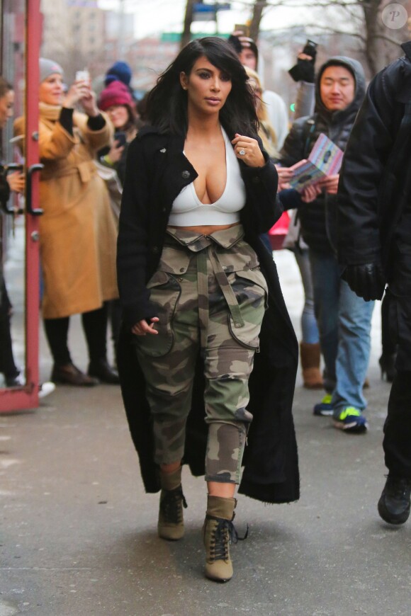 Kim Kardashian visited a few retail stores in Soho this afternoon in New York City, NY, USA on February 09, 2015. The reality TV star, who attended the 57th Annual Grammy Awards with hubby West last night, wore a tiny white top showing off a lot of cleavage, a black maxi cardigan and camo baggy trousers matching her olive green lace up booties. Photo by GSI/ABACAPRESS.COM10/02/2015 - New York City