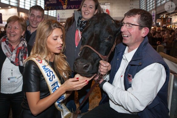 Camille Cerf, Miss France 2015, rend visite à la vache Filouse, au Salon de l'Agriculture à Paris, le mardi 24 février 2015.