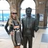Paris Hilton arrive à la gare de Liverpool, le 13 mai 2015. Elle prend le temps de poser avec ses fans et avec une statue !. Elle est à Liverpool pour aller fêter le premier anniversaire de son parfum au Superdrug. 