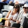 Patrick Bruel et sa compagne Caroline dans les tribunes des Internationaux de France de tennis de Roland Garros le 30 mai 2015.30/05/2015 - Paris