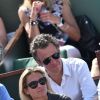 Anne-Sophie Lapix et son mari Arthur Sadoun dans les tribunes de Roland-Garros lors de la finale homme, le 7 juin 2015 à Paris