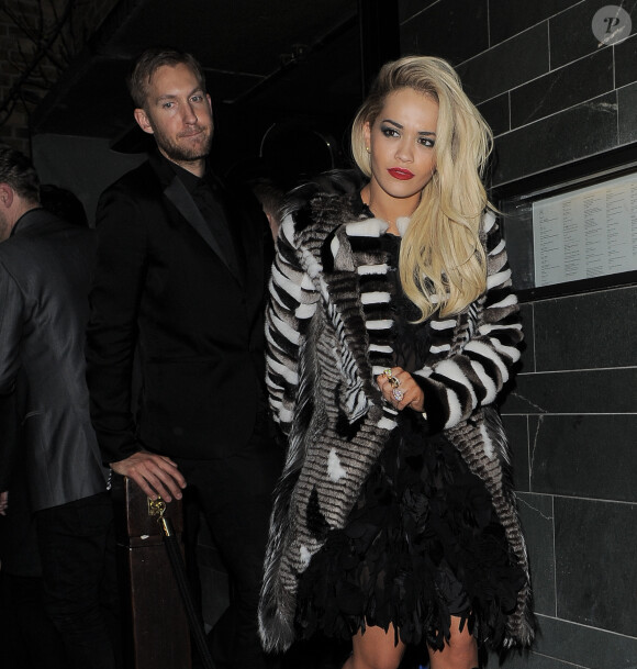 Rita Ora et son petit-ami Calvin Harris - People à la sortie de l'After-Party au restaurant Hakkasan après la soirée des Brit Awards à Londres, le 19 février 2014.  