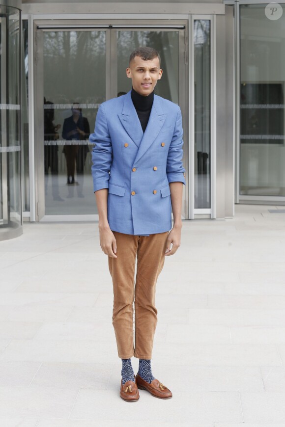 Stromae  à la sortie du défilé de mode Louis Vuitton, collection prêt-à-porter automne-hiver 2015/2016, à Paris, le 11 mars 2015