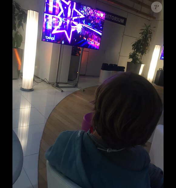 Oscar, le fils aîné de Sandrine Corman regarde l'émission que présente sa maman. Juin 2015.