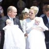Le prince Albert II de Monaco avec la princesse Gabriella et la princesse Charlene de Monaco avec le prince Jacques lors du baptême des jumeaux princiers sur le Rocher le 10 mai 2015