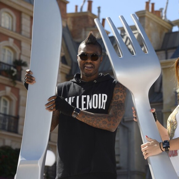 Djibril Cissé et sa compagne MArie-Cécile lors de la présentation en avant-première de la nouvelle attraction "Ratatouille : L'aventure totalement toquée" à Disneyland Paris à Marne-la-Vallée, le 21 juin 2014