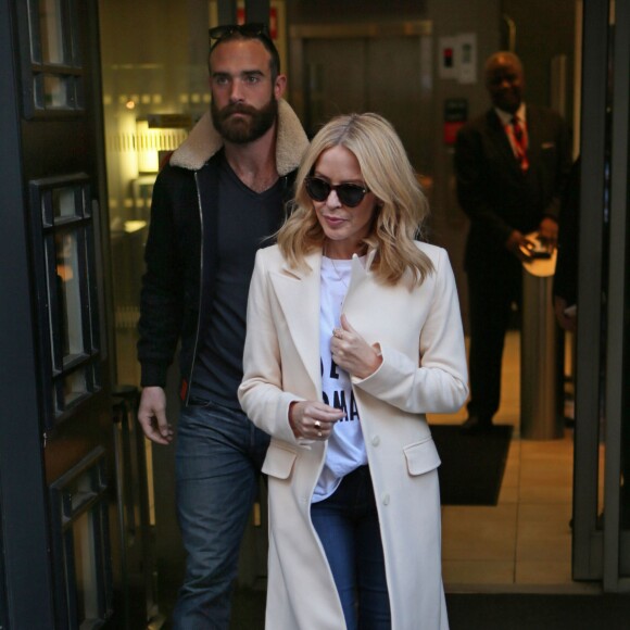 Kylie Minogue et son compagnon Joshua Sasse quittent les studios de la BBC Radio 2 à Londres le 4 décembre 2015.  Singer Kylie Minogue leaving BBC Radio 2 with her actor boyfriend Joshua Sasse. Kylie just returned from a trip in Paris with her new man, was appearing on the Chris Evans Breakfast Show - London04/12/2015 - Londres