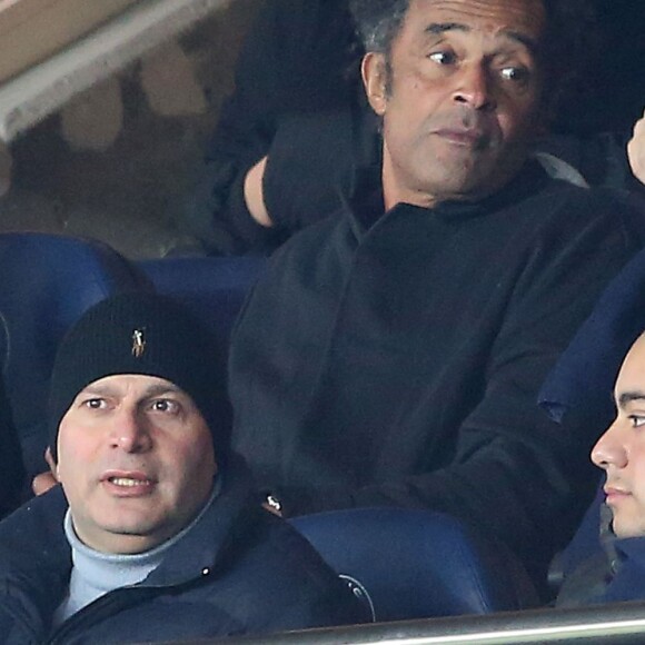 Yannick Noah et son fils Joalukas lors de la rencontre entre le PSG et Chelsea en 8e de finale de la Ligue des champions, au Parc des Princes à Paris le 16 février 2016 © Cyril Moreau