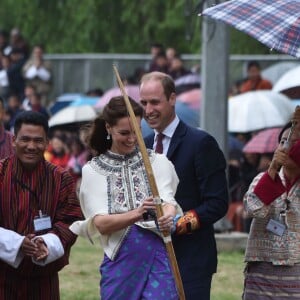 Kate Catherine Middleton, duchesse de Cambridge, s'exerce au tir à l'arc sous l'oeil amusé du prince William, duc de Cambridge, à Thimphou, à l'occasion de leur voyage officiel au Bhoutan. Le 14 avril 2016  14 April 2016. The Duke and Duchess of Cambridge in Bhutan at Thimphu's open-air archery venue after watching a display both of them tried Archery and a Darts Game.14/04/2016 - Thimphu