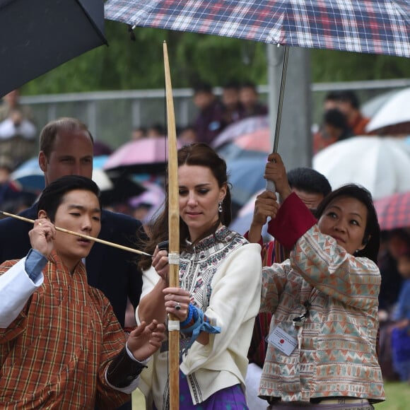 Kate Catherine Middleton, duchesse de Cambridge, s'exerce au tir à l'arc sous l'oeil amusé du prince William, duc de Cambridge, à Thimphou, à l'occasion de leur voyage officiel au Bhoutan. Le 14 avril 2016  14 April 2016. The Duke and Duchess of Cambridge in Bhutan at Thimphu's open-air archery venue after watching a display both of them tried Archery and a Darts Game.14/04/2016 - Thimphu