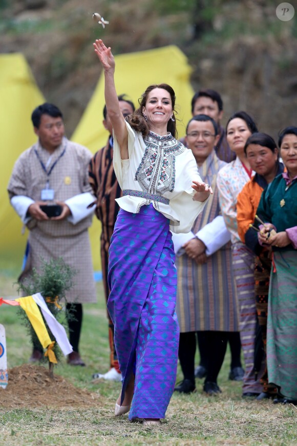Kate Catherine Middleton, duchesse de Cambridge, s'exerce au tir à l'arc sous l'oeil amusé du prince William, duc de Cambridge, à Thimphou, à l'occasion de leur voyage officiel au Bhoutan. Le 14 avril 2016  The Duchess of Cambridge throwing a dart at an archery event in Thimphu, Bhutan, during day five of the royal tour to India and Bhutan.14/04/2016 - Paro