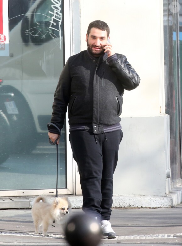 Exclusif - Mouloud Achour promène son chien dans les rues de Paris le 17 mars 2016.