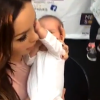 Nabilla Benattia porte un bébé lors de sa séance de dédicaces à Bordeaux, dimanche 26 juin 2016