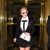Lady Gaga quitte le Bristol à Paris, habillée en Valentin Yudashkin (collection Haute Couture printemps-été 2016). Des lunettes Onkler, un sac Cambridge Satchel Company (modèle Mini Poppy), des chaussettes Pierre Mantoux et des chaussures Casadei accessoirisent sa tenue. Le 28 novembre 2016.