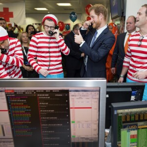 Le prince Harry participe avec d'autres personnalités du monde du sport, de la télévision à la 24ème journée de collecte de fonds caritative dans une salle de l'ICAP à la City à Londres, le 7 décembre 2016.