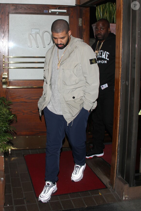Drake and his entourage leave Madeo Italian restaurant in West Hollywood. The Canadian rapper dressed casual in a tan coat over a grey top, blue track pants and a pair of Nike, Los Angeles, CA, USA on April 4, 2017. Photo by Spread Pictures/ABACAPRESS.COM05/04/2017 - Los Angeles