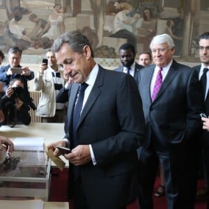 Nicolas Sarkozy et son épouse Carla Bruni-Sarkozy votent pour le premier tour des élections présidentielles au lycée La Fontaine à Paris le 23 avril 2017.