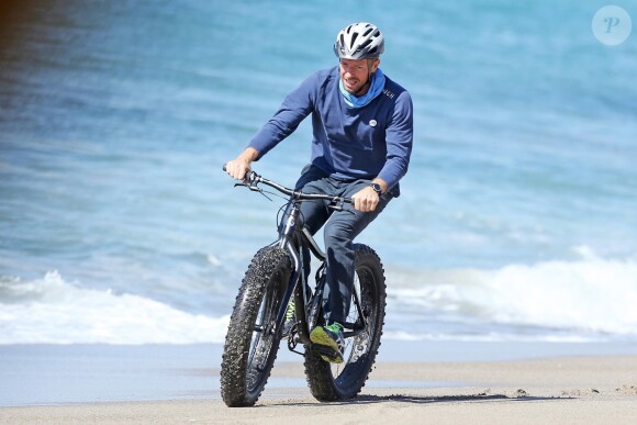 Exclusif - Chris Martin fait du VTT avec un ami sur la plage à Malibu. Los Angeles, le 13 février 2018.